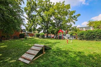 a backyard with a picnic table and a swing set
